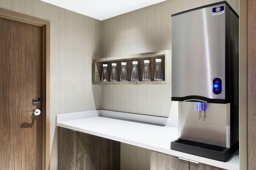 a refrigerator sitting on a shelf in a room at AC Hotel by Marriott Huntsville Downtown in Huntsville