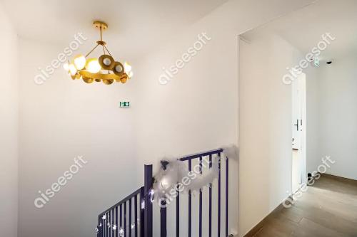 a chandelier in a white room with a staircase at KoalaWakeup in Vitry-sur-Seine
