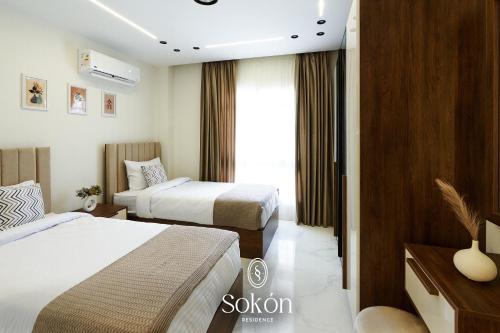 a hotel room with two beds and a window at Sokon Residence at Madinaty B7,G74 in Madinaty
