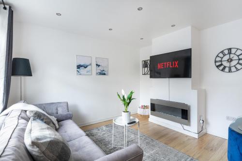 a living room with a couch and a tv at City Gem - 2 Bed House, 6 mins from Liverpool Street, Shops & Restaurants in London