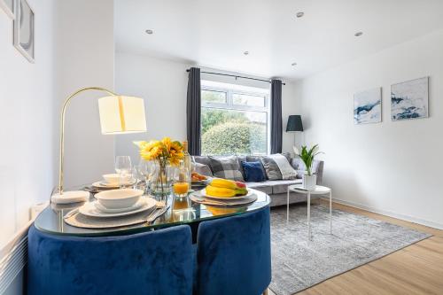a living room with a blue table with food on it at City Gem - 2 Bed House, 6 mins from Liverpool Street, Shops & Restaurants in London