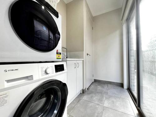 a laundry room with a washing machine and a window at five-room house next to the park16 in Altona Meadows