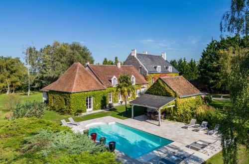an aerial view of a house with a swimming pool at Domaine de la Blonnerie in Feings