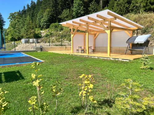 a gazebo with a grill in a yard at Horska Rezort in Ružomberok