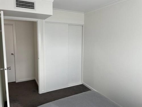 an empty room with white walls and a door at New 3 bedroom house in Cooma in Cooma