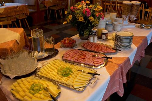 a table with many plates of food on it at Appartements Bergheim in Hirschbichl