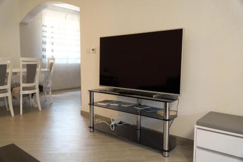 a living room with a flat screen tv on a table at Yellow House in Pilipets