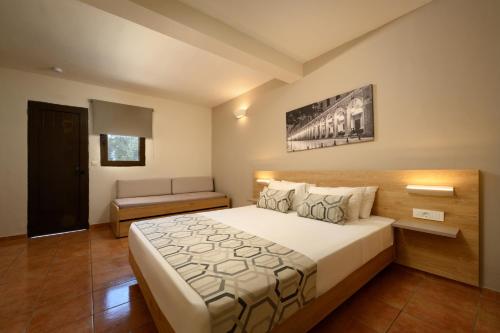 a bedroom with a large bed in a room at Sunshine Corfu Hotel And Spa in Nisakion