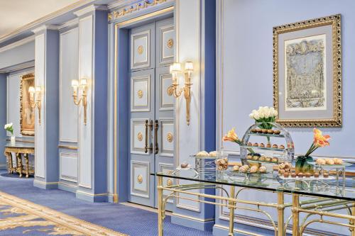 a lobby with blue walls and a table with food at Four Seasons Hotel Alexandria At San Stefano in Alexandria