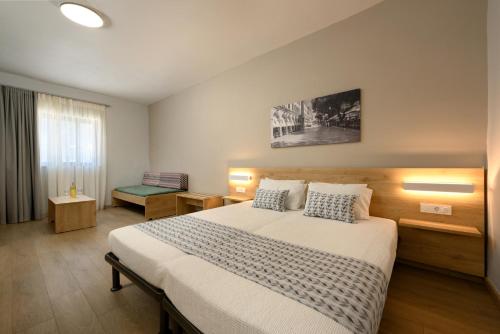 a bedroom with a large bed in a room at Sunshine Corfu Hotel And Spa in Nisakion