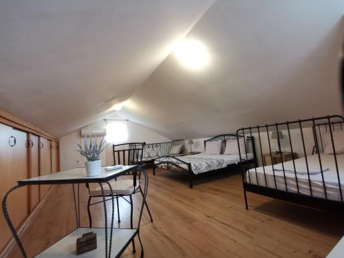 a room with two bunk beds and a table at Robinson crusoe style house "MASLINA'' in Škrip
