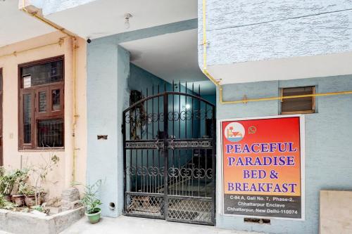 a sign on the side of a building with a gate at Hotel O Peaceful Paradise in New Delhi