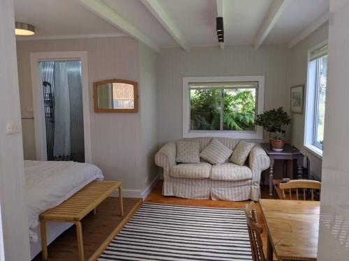 a living room with a bed and a couch at Seascape Studio in Tomakin