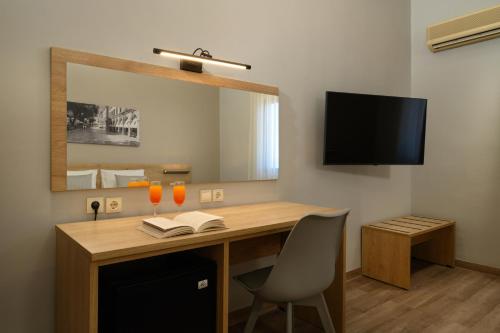 a room with a desk with a mirror and a chair at Sunshine Corfu Hotel And Spa in Nisakion