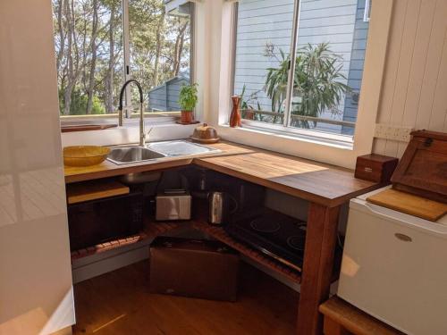 a kitchen with a counter and a sink and a sink at Seascape Studio in Tomakin