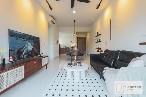 a living room with a couch and a tv at Greenfield Residence, Bandar Sunway by The Comfort Zone in Petaling Jaya