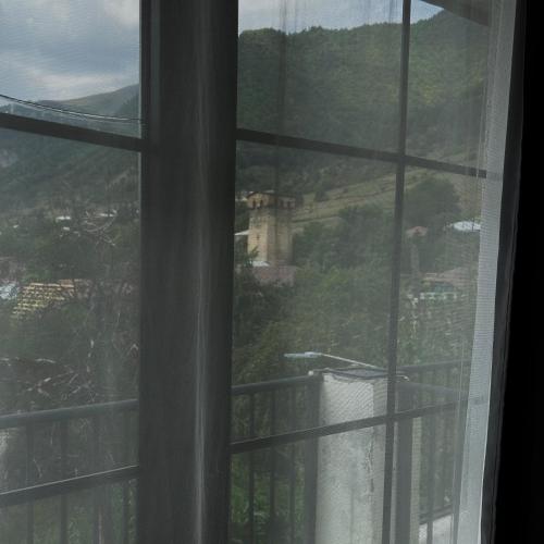 a window with a view of a castle at Boutique hotel mestia in Mestia