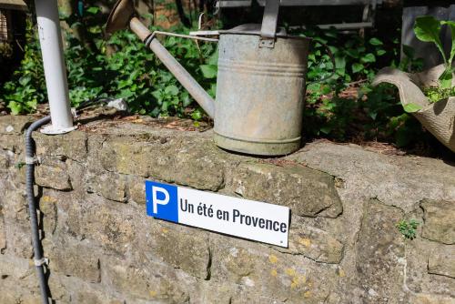 a sign on top of a stone wall with a bucket at VILLA NOTRE DAME face au Château fort in Sedan
