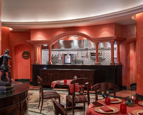 a restaurant with a table and chairs and a kitchen at Four Seasons Hotel Alexandria At San Stefano in Alexandria