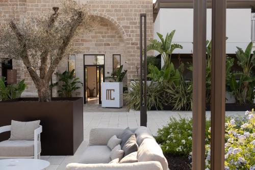 a living room with a couch and some plants at Masseria Corsano in Nardò