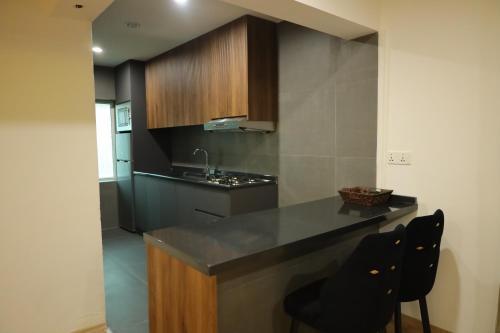 a kitchen with a counter and two chairs in it at Shingelbana Resort in Rawandoz