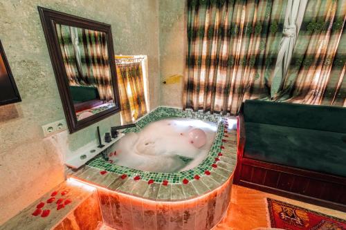 a bath tub in a bathroom with at Tafana Cave & Stone Lodge in Urgup