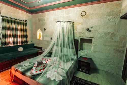 a bedroom with a bed and a sink and a mirror at Tafana Cave & Stone Lodge in Urgup