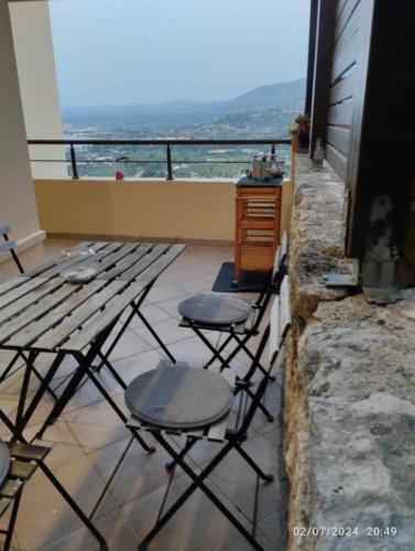 two chairs and a table on top of a balcony at Rosemary Grand View in Exopoli