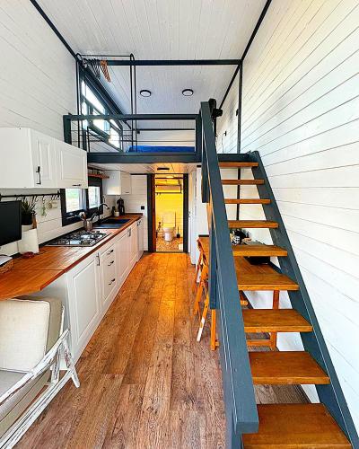 a kitchen with a staircase leading up to a loft at Dolce Vita Söğüt in Marmaris