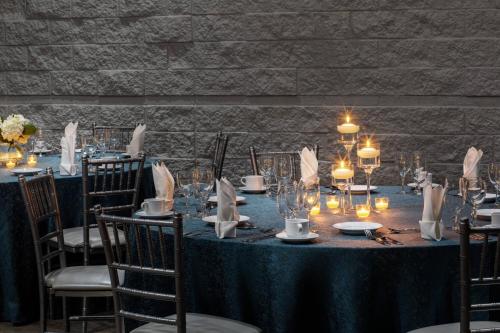 a table set up for a wedding with candles at Macon Marriott City Center in Macon