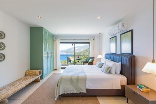 a bedroom with a bed and a view of the ocean at Villa Korsan- 8 Bedroom Villa with Private Pool and Sea View in Kas