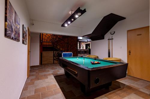 a room with a pool table in a room at Penzión Lomnicky in Stará Lesná