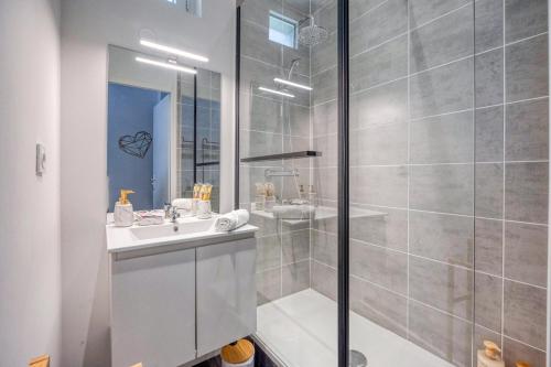 a white bathroom with a shower and a sink at L'As de Coeur - Rocade - Tram in Grenoble
