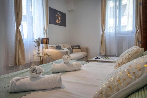 a living room with two beds and a couch at L'As de Coeur - Rocade - Tram in Grenoble