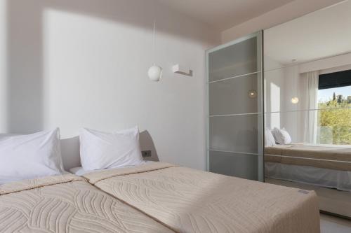 a bedroom with a large bed and a window at Elia Luxury Villa in Akrotiri