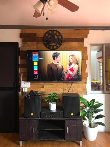 a flat screen tv on a wall in a living room at Travelers Hub 1 Camella Tarlac in Tarlac