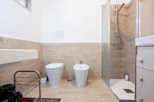 a bathroom with a toilet and a sink and a shower at PIAZZA LAURINO Apartments in Laurino