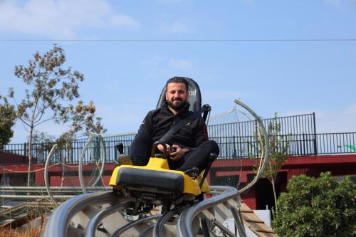 a man sitting on a ride on a roller coaster at Shingelbana Resort in Rawandoz