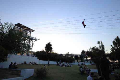 a person is flying over a group of people at Shingelbana Resort in Rawandoz