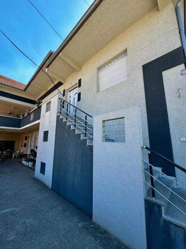 a building with a staircase on the side of it at Lovely Apartment with terrace/Divan apartman sa terasom in Novo Selo