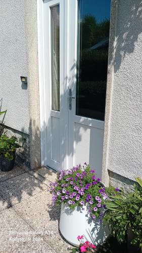 a white door with a bunch of flowers in front of it at Casa Germana in Invorio Inferiore