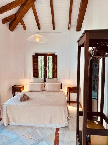 a bedroom with a large bed and a table at Hotelito Suecia in Granada