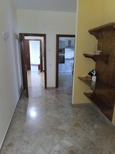 an empty living room with a hallway and a room with a unintention at affittacamere girasole in Montesarchio