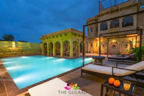 a swimming pool in front of a building at The Gulaal in Jaisalmer