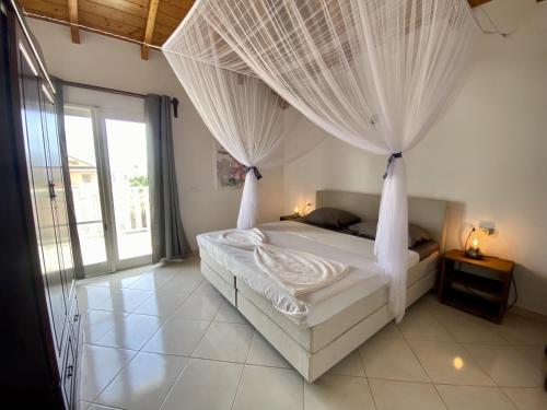 a bedroom with a bed with curtains over it at Estrela do Mar - Rooftop Ocean View in Santa Maria