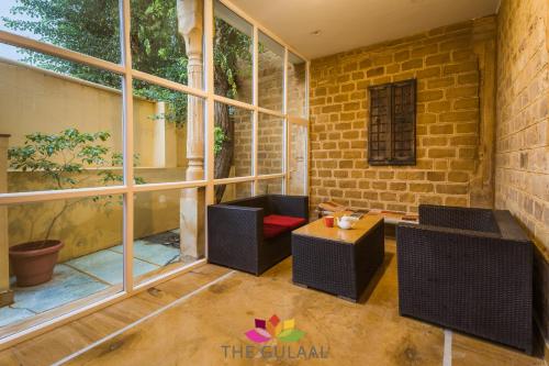 a patio with two chairs and a table at The Gulaal in Jaisalmer