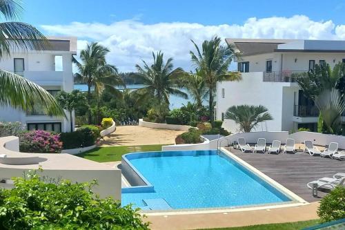 a villa with a swimming pool and a resort at Luxury 3 Bedroom Apartment Sea View Azuri Estate in Roches Noires
