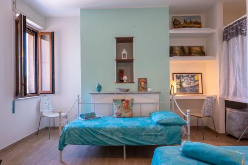 a bedroom with a bed and two chairs at PIAZZA LAURINO Apartments in Laurino