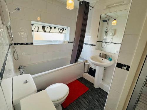 a bathroom with a white toilet and a sink at Contractors families free parking Ramsey Road in St Ives