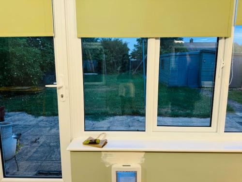 a window with a view of a yard at Contractors families free parking Ramsey Road in St Ives